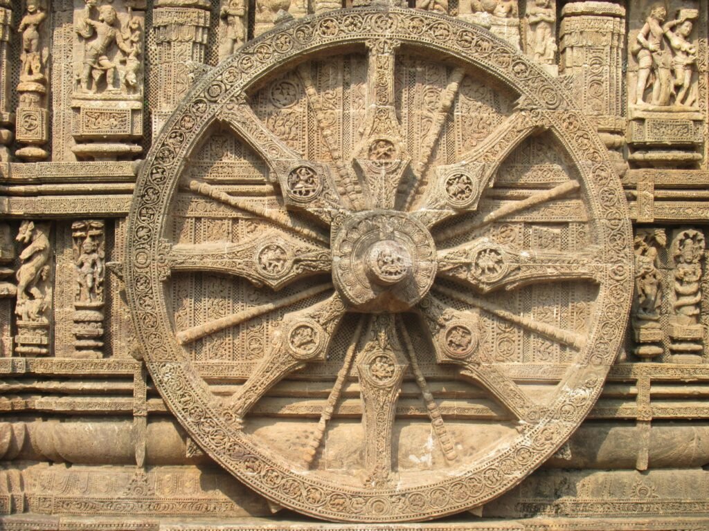 Intricate stone wheel carving from the Konark Sun Temple, showcasing exquisite architecture.